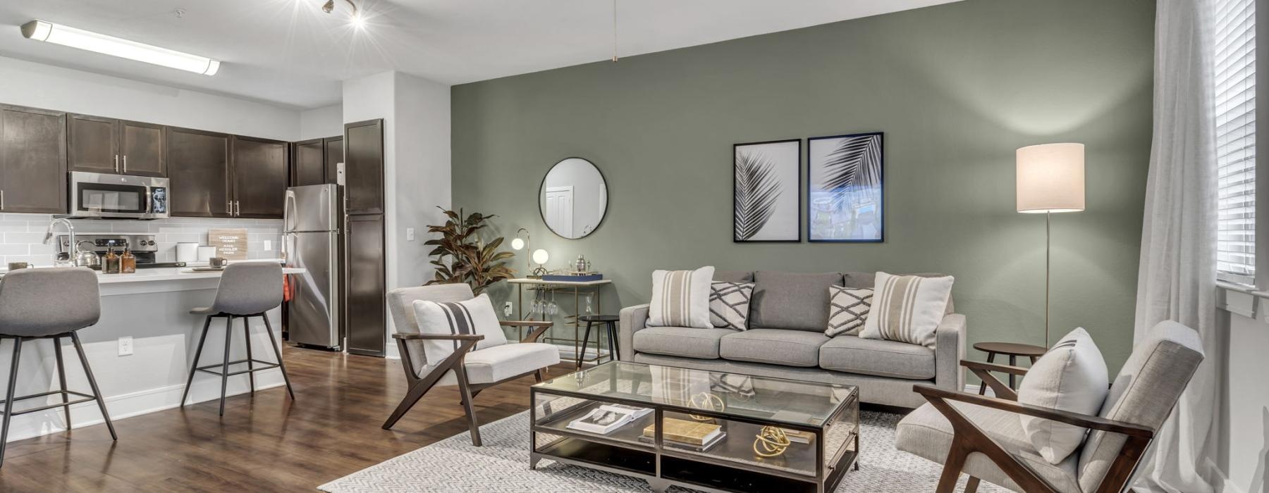 Open-concept living room and kitchen at Axis Kessler Park, offering optional furnished apartments in Dallas